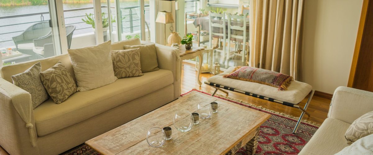 The interior of a modern apartment decorated comfortably with huge windows